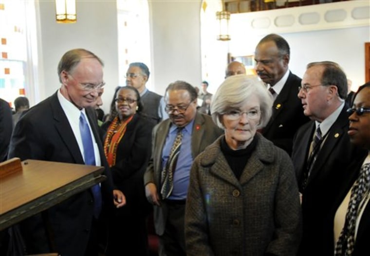 Newly sworn in Alabama Governor Robert Bentley, left, and his wife, Dianne, prepare to leave Dexter Avenue King Memorial Baptist Church after he spoke during the annual observance of Dr. Martin Luther King's birthday on Monday in downtown Montgomery, Ala.